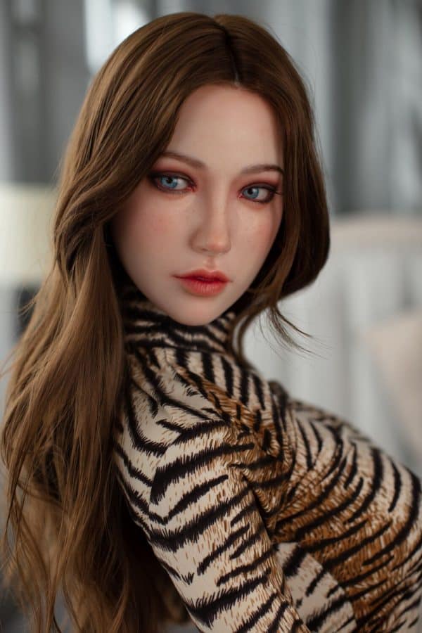 Realistic female doll with striking blue eyes and auburn hair, wearing a stylish animal print top. Perfect for lifelike companionship and intimate moments.