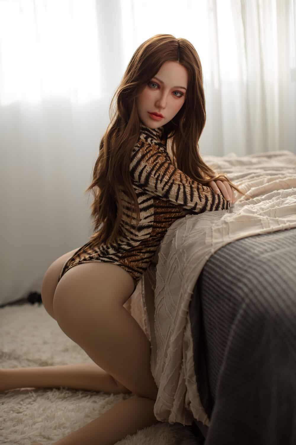 Realistic sex doll woman in animal print bodysuit, soft skin, long hair, seductive pose.