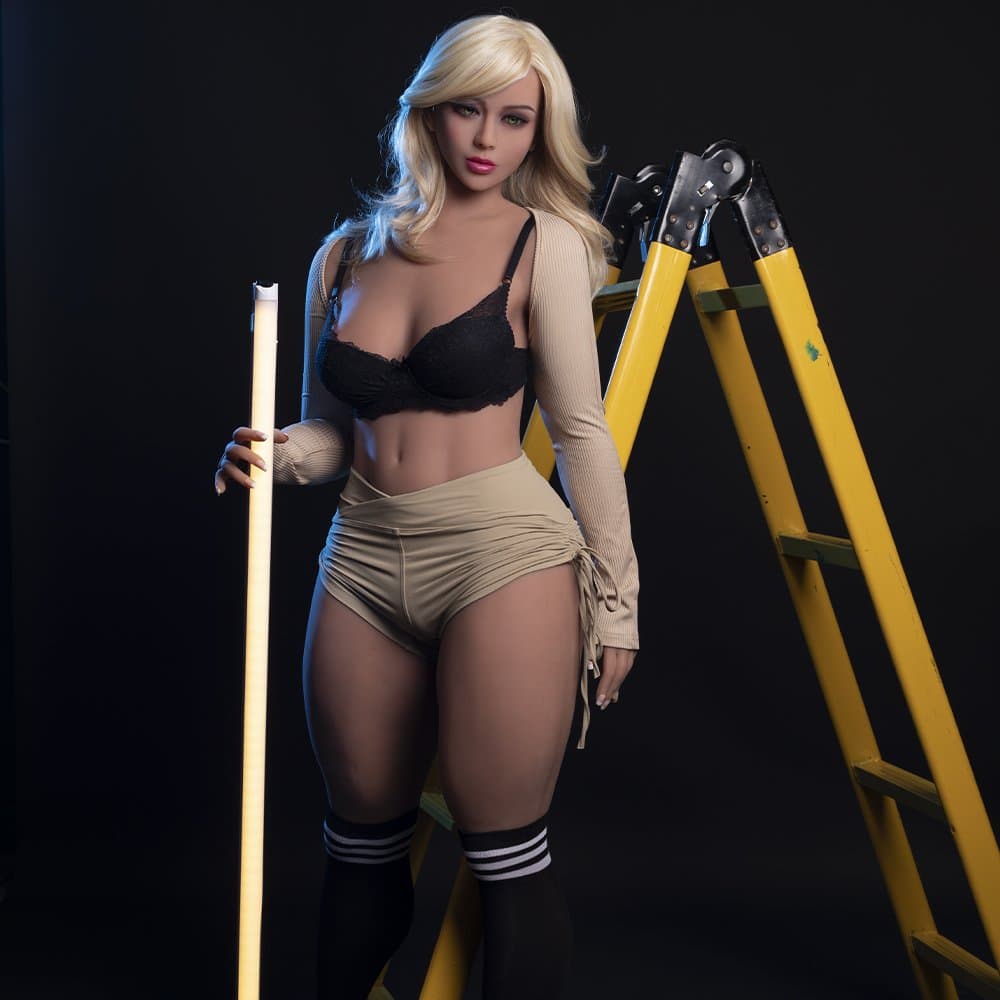 Realistic female doll with blonde hair holding a light stick next to a yellow ladder, sexy lingerie and fashion style, seducedoll.com.