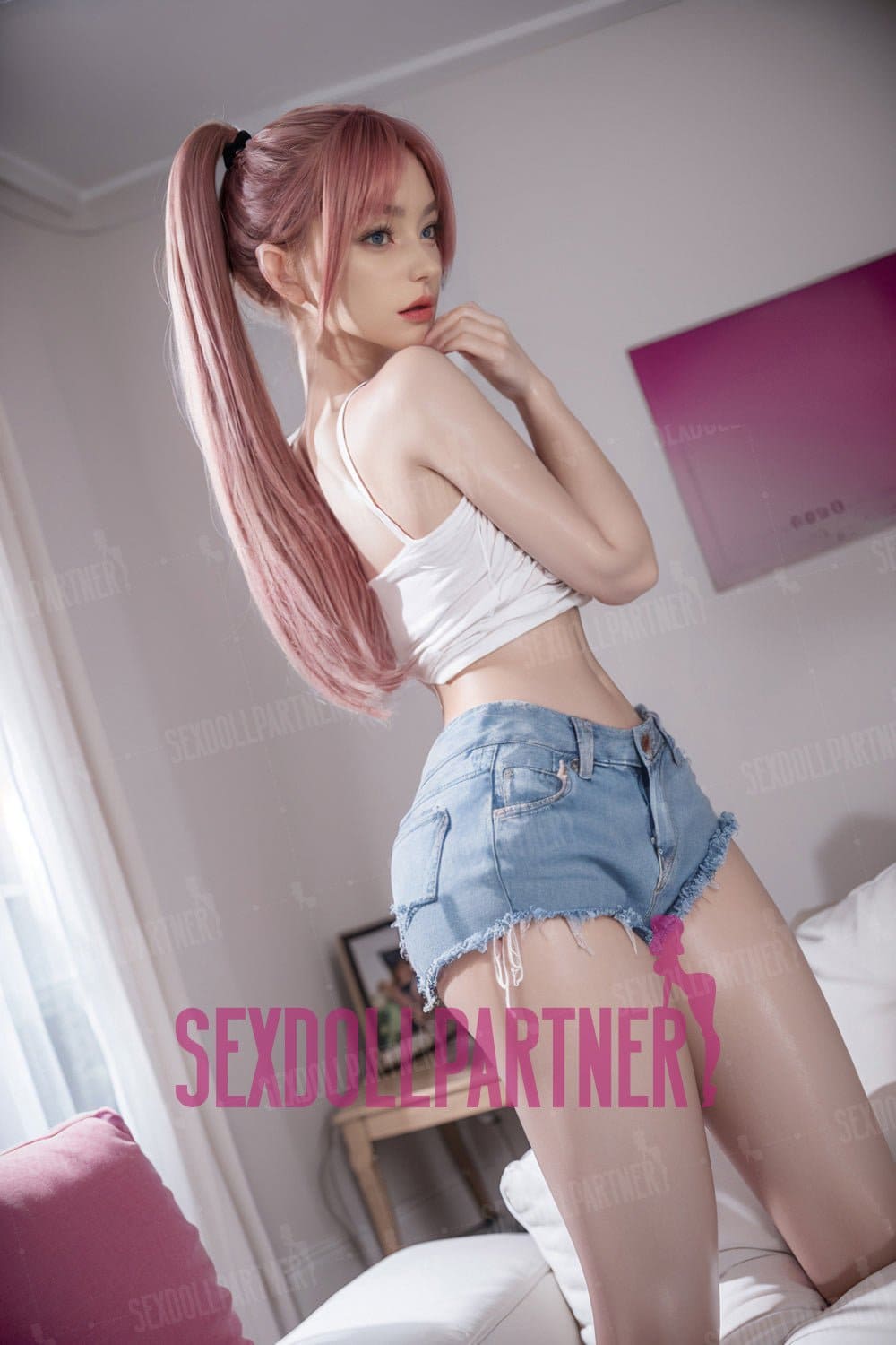 A lifelike sex doll with pink hair in casual clothing guides for adult pleasure.