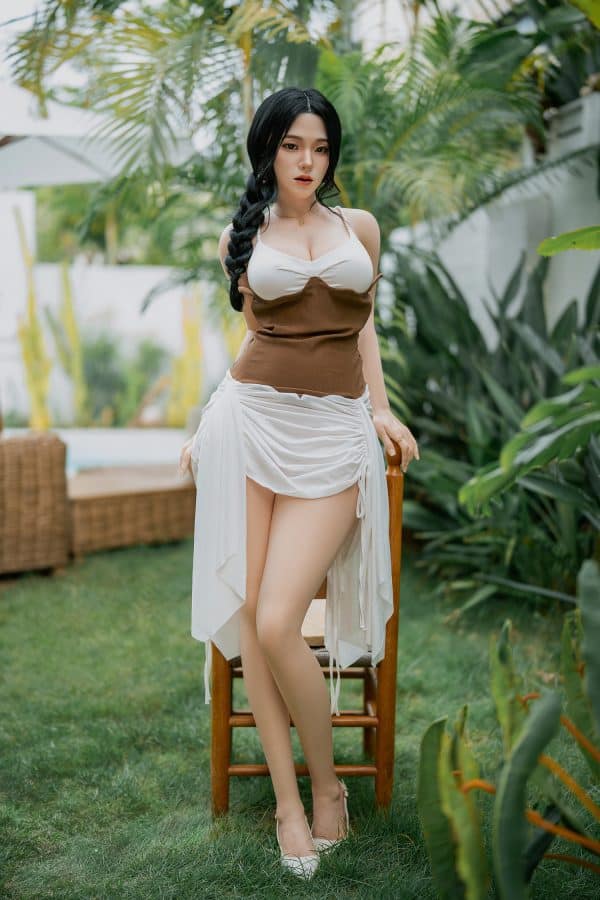 Silicone doll in garden, realistic erotic art, seducedoll.com promotional image, outdoor swimsuit woman with dark hair and tan skin, ideal for adult product SEO.