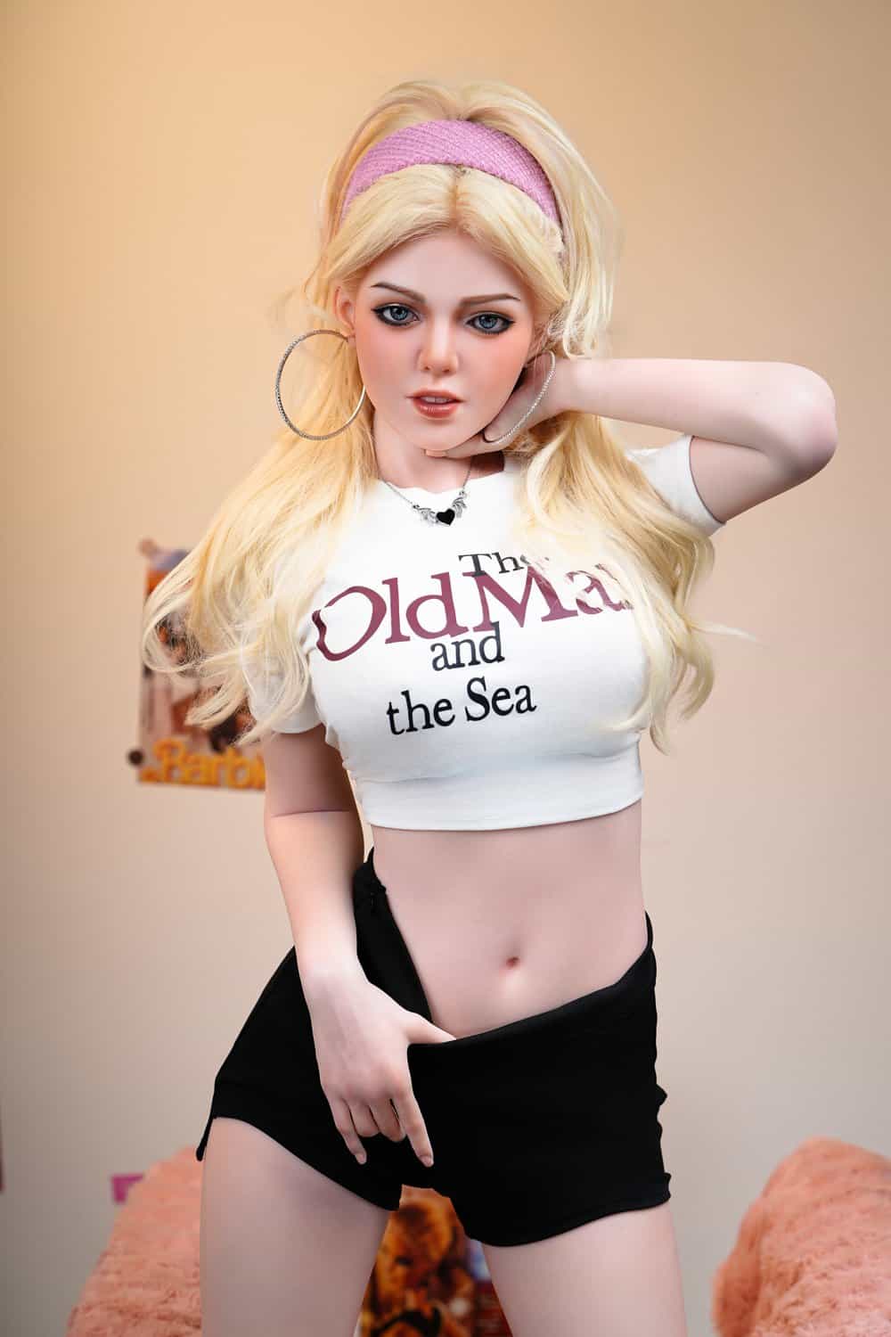 Realistic sex doll, blonde with earrings, posing in casual outfit for intimate companionship.