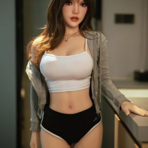 Realistic love doll modeled after a young woman in casual athletic wear for bedroom or intimate settings.