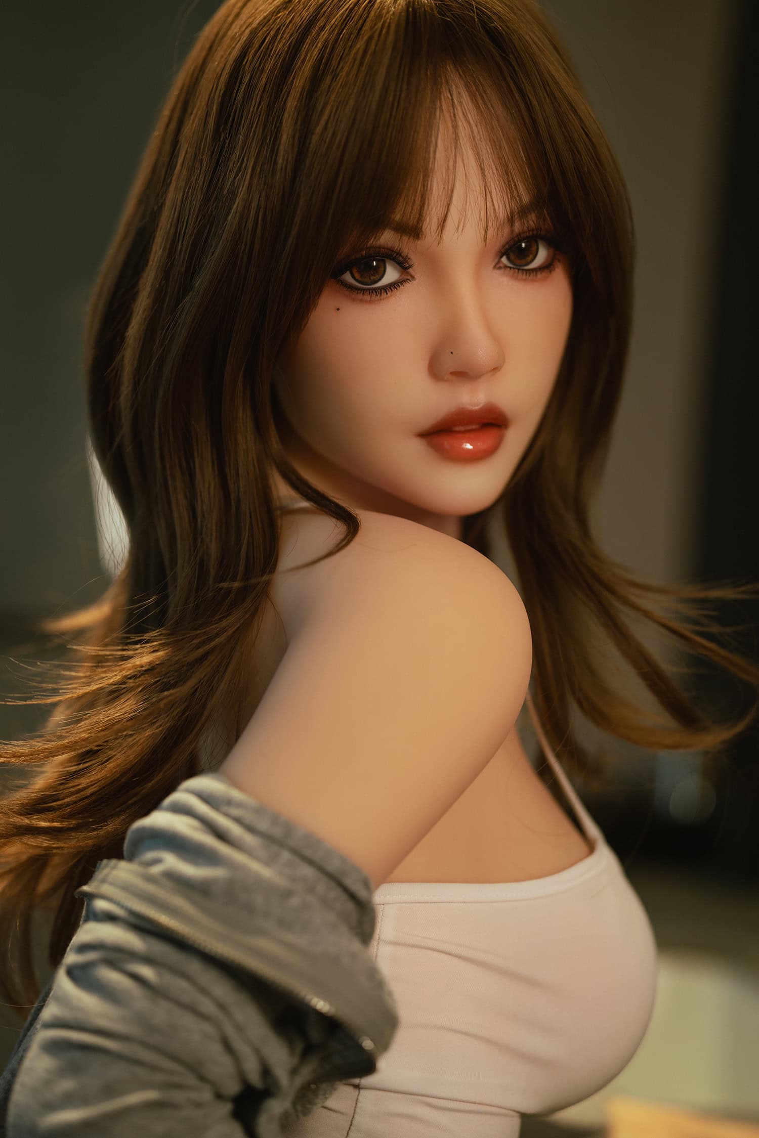 Realistic female doll with brown hair and detailed features for adult pleasure.