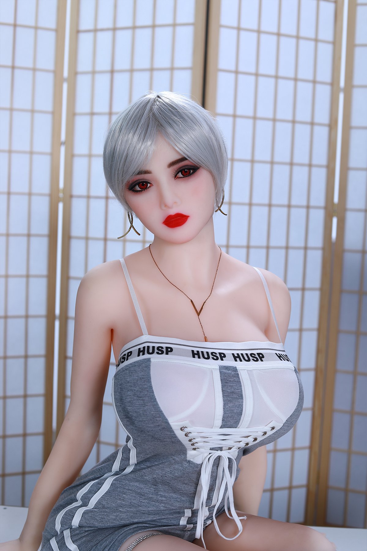 Realistic sex doll with silver hair, red eyes, and stylish outfit in a modern setting.