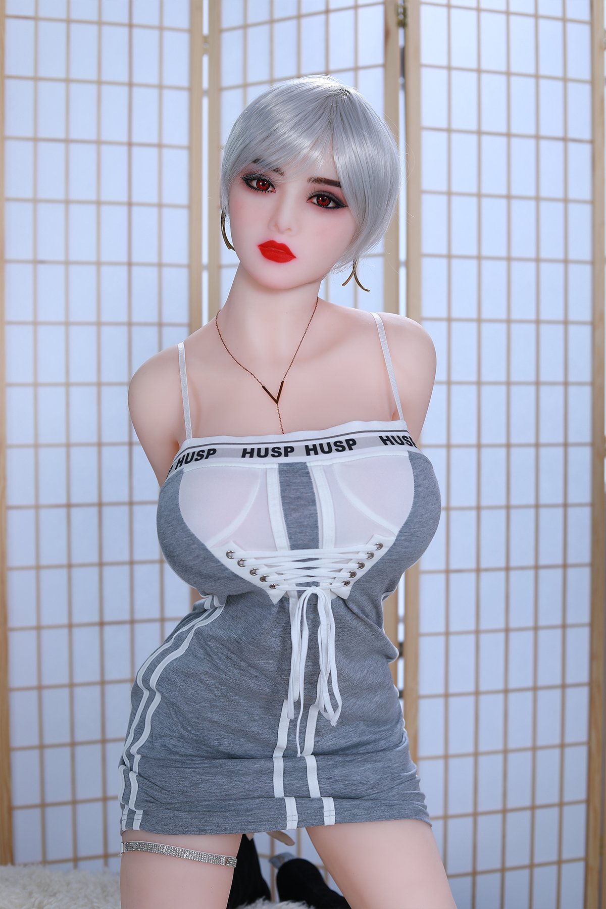 Realistic sex doll with silver hair, red makeup, and trendy dress in a stylish room, showcasing adult love doll features.