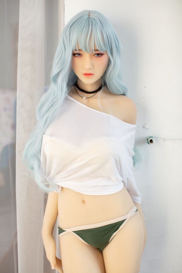 Realistic female love doll with long wavy blue hair posing indoors.
