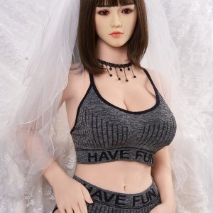 Realistic sex doll with brown hair dressed in casual athletic wear and wedding veil, posing on lace background.