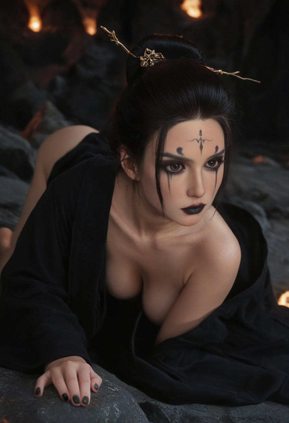Ethereal gothic doll with dark makeup and intricate facial tattoos, posed on rocks in a mysterious dark setting.