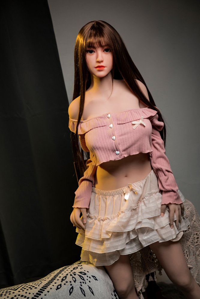 Realistic love doll with long brown hair and cute outfit for adult companionship.