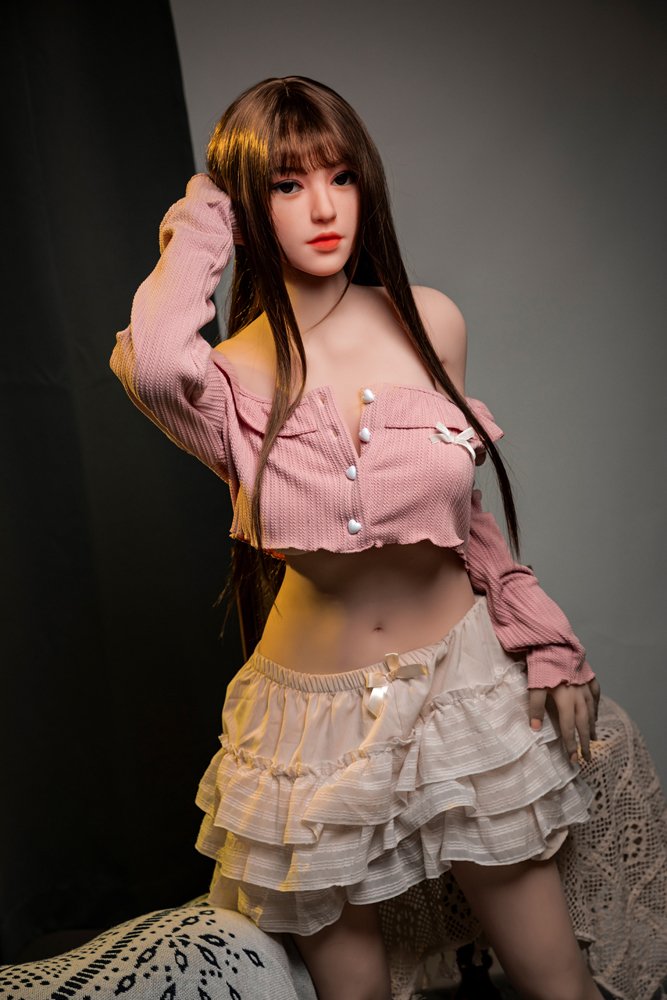 Silicone love doll in pink top and ruffled skirt for realistic companionship and intimacy.