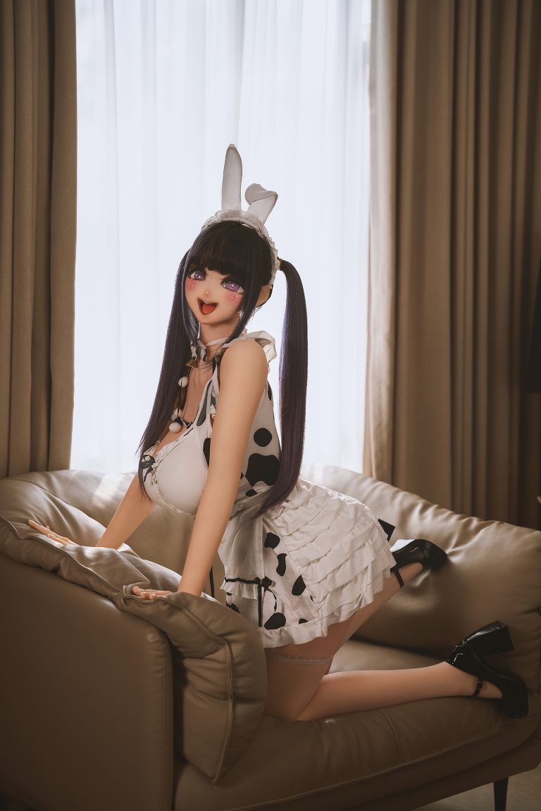 Realistic sex doll in bunny costume on sofa, detailed and lifelike, perfect for adult intimacy entertainment.
