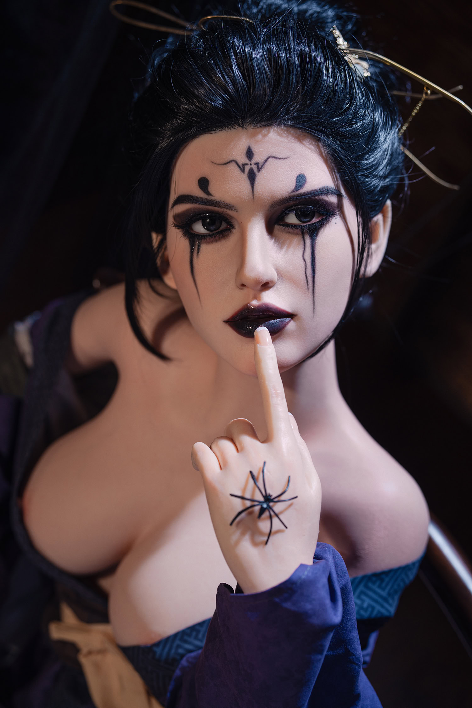 Sinister woman with gothic makeup, black lipstick, and spider ring, seductive look, dark blue costume, Halloween or fantasy theme, seductive doll image, mysterious allure.