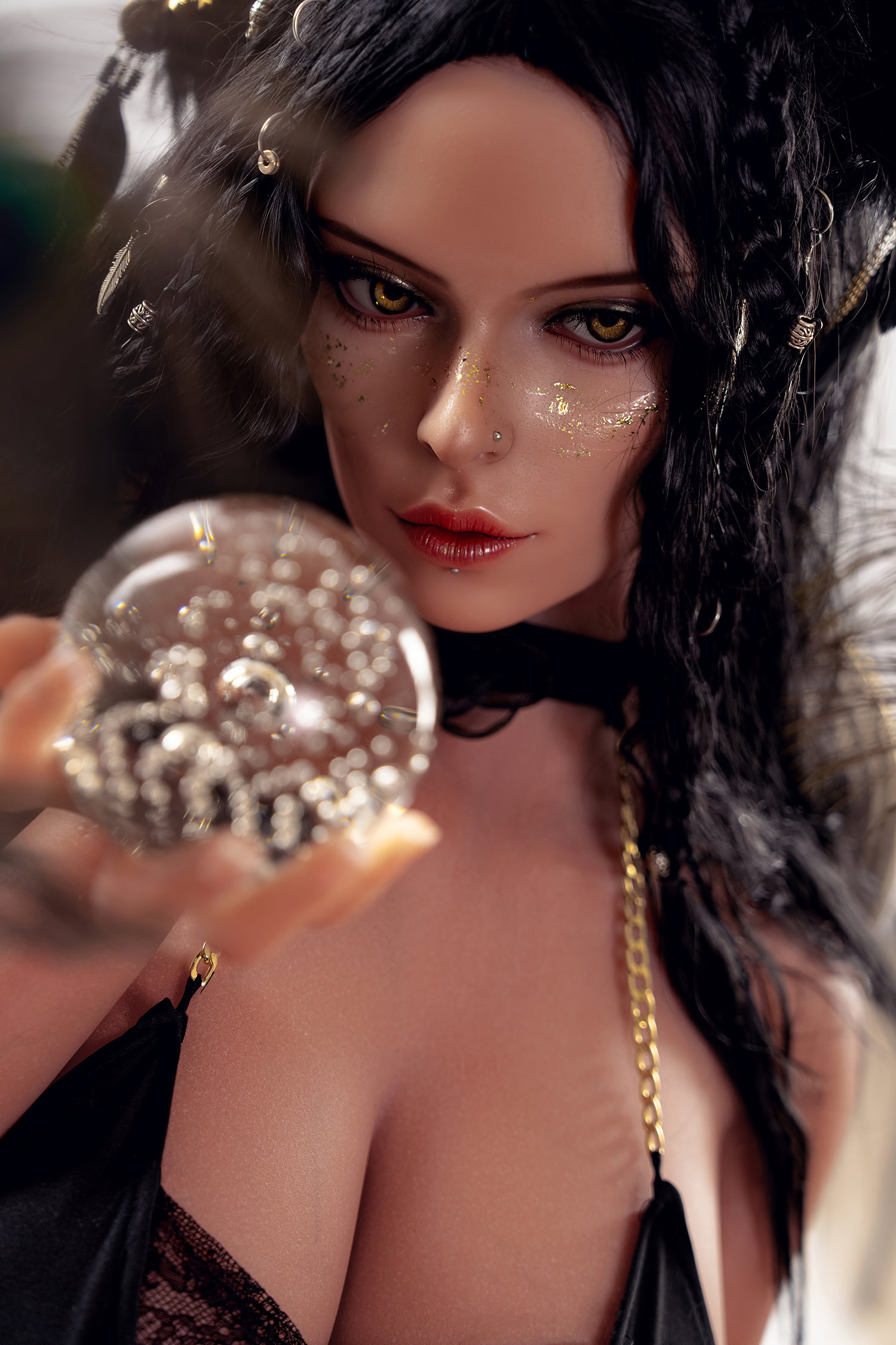 Intricate fantasy-themed female doll holding reflective crystal ball with gold accents, black hair, golden jewelry, detailed makeup, seductive expression, seductive doll from seducedoll.com.