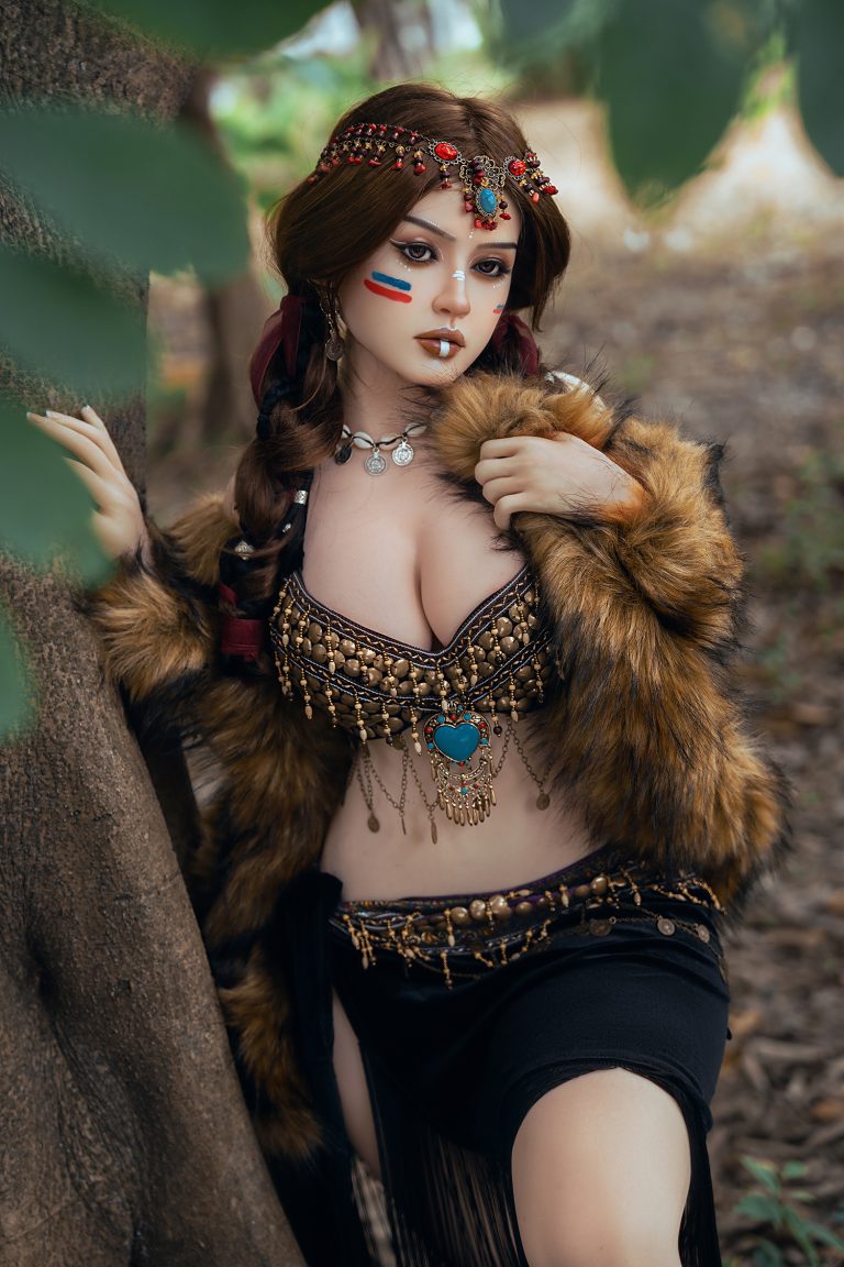 Elegant sex doll with tribal-inspired accessories, fur coat, and detailed face paint in forest setting.