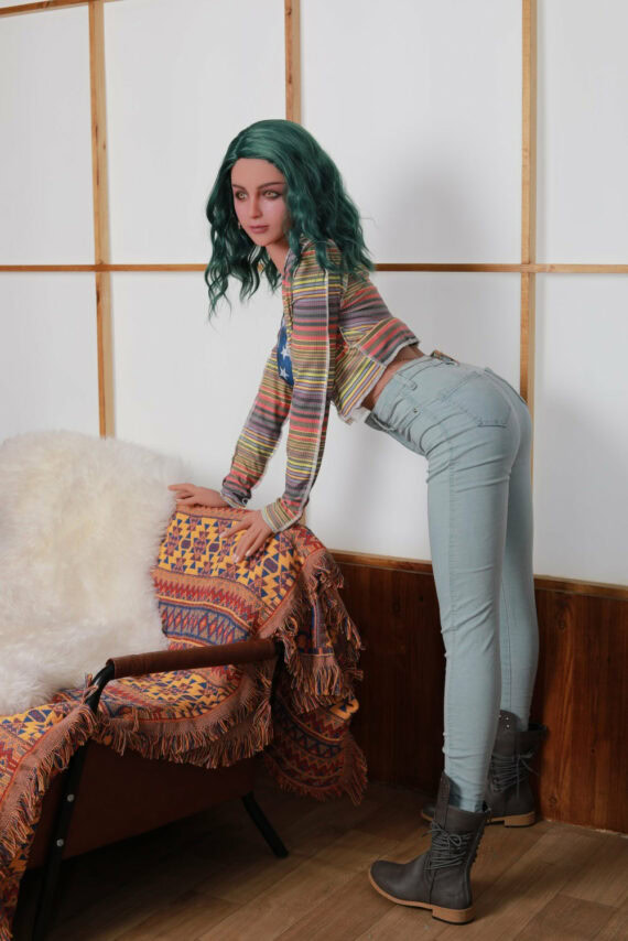 Realistic sex doll woman with green hair and casual outfit posing indoors.