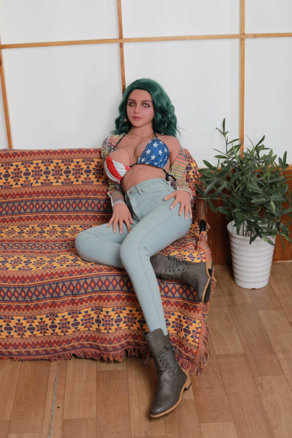 Seducedoll realistic female doll with green hair sitting on colorful sofa for adult entertainment.
