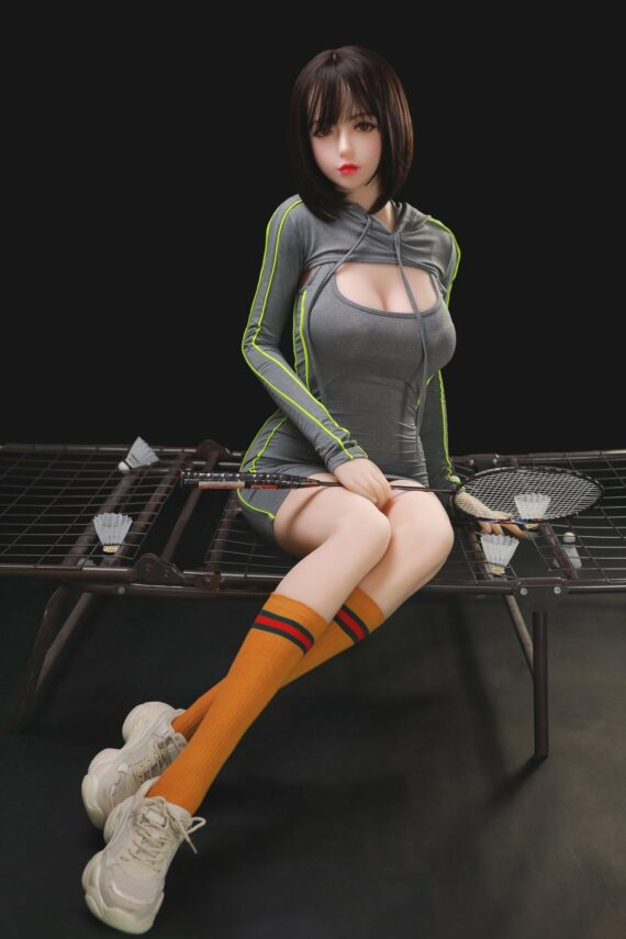 Realistic female doll sitting on badminton court, wearing sporty hoodie and colorful knee-high socks.