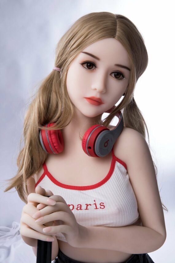 Realistic female doll with long blonde hair and headphones, posing in casual attire for seducedoll.com.