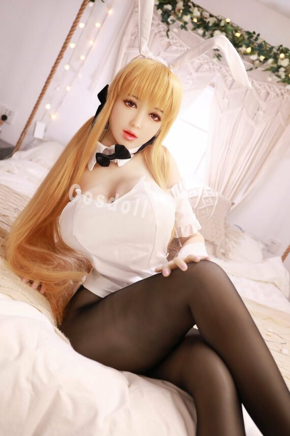 Cosdoll blonde anime girl doll with bunny ears, cosplay lingerie, bedroom scene.