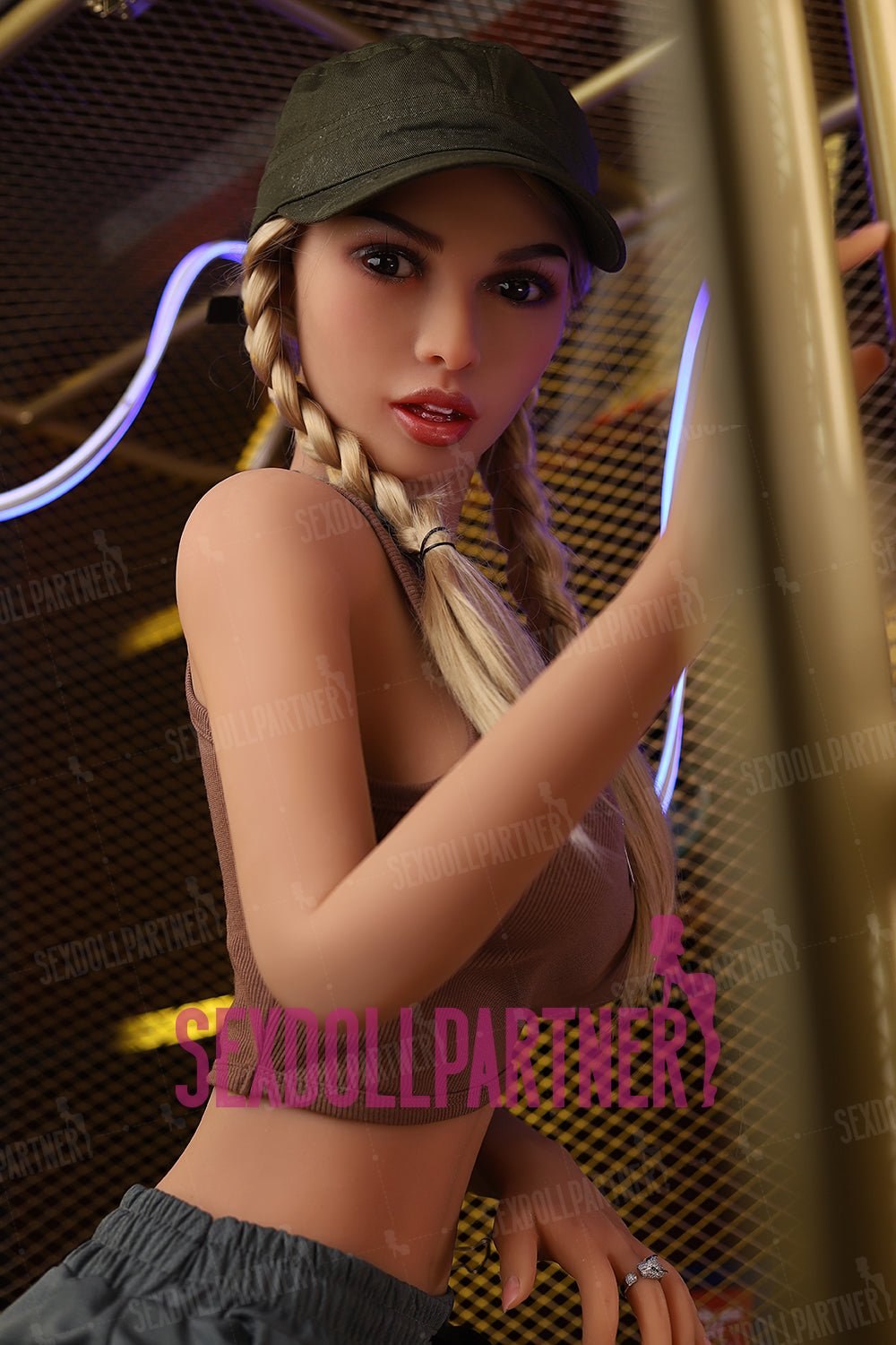 Cute blonde woman with braided hair wearing a cap in an industrial setting, promoting sex dolls and adult companionship.