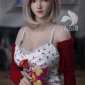 Realistic female love doll with blonde hair and floral dress holding potato chips.