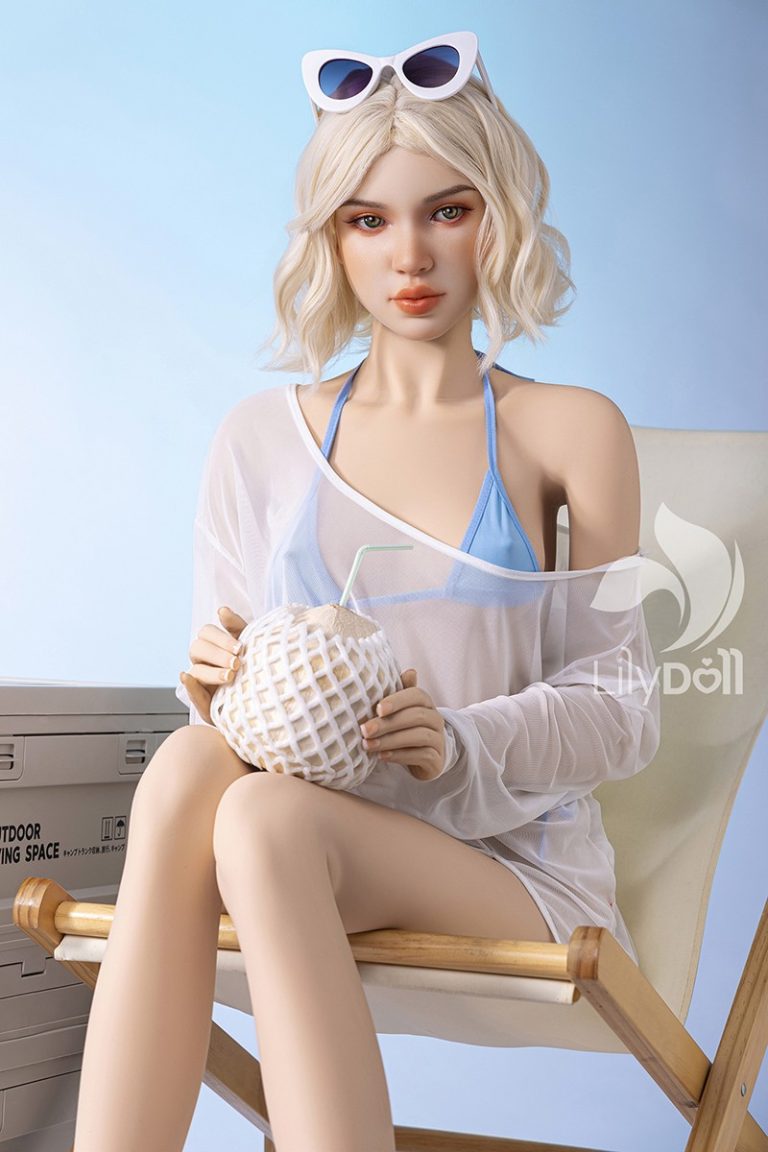 Realistic sex doll with blonde hair holding a coconut drink, summer beach style, seducedoll.com.