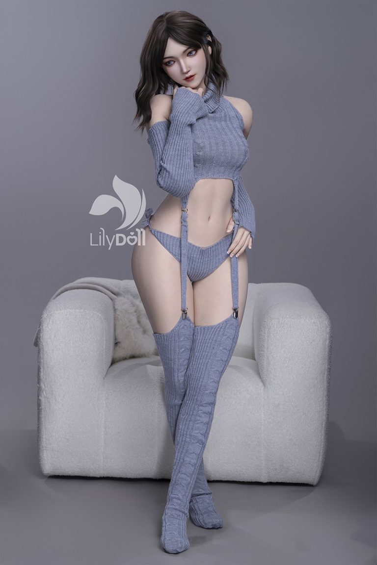 Silicone love doll wearing gray knit lingerie and thigh-high socks, posed on a plush white armchair.