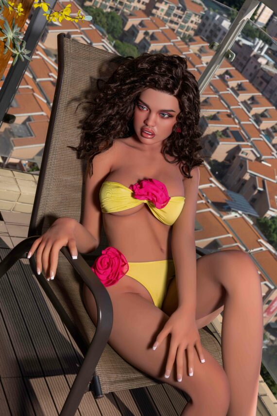 Seductive doll female mannequin in yellow bikini with pink flowers on balcony.