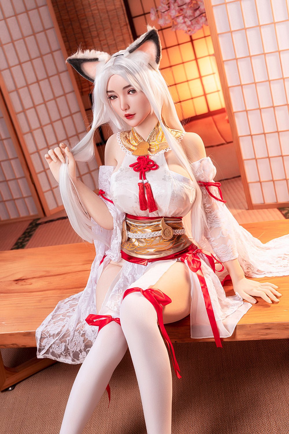 Seductive anime-inspired fox girl cosplay sitting on wooden table in traditional Japanese room with shoji screens and cherry blossom decor.