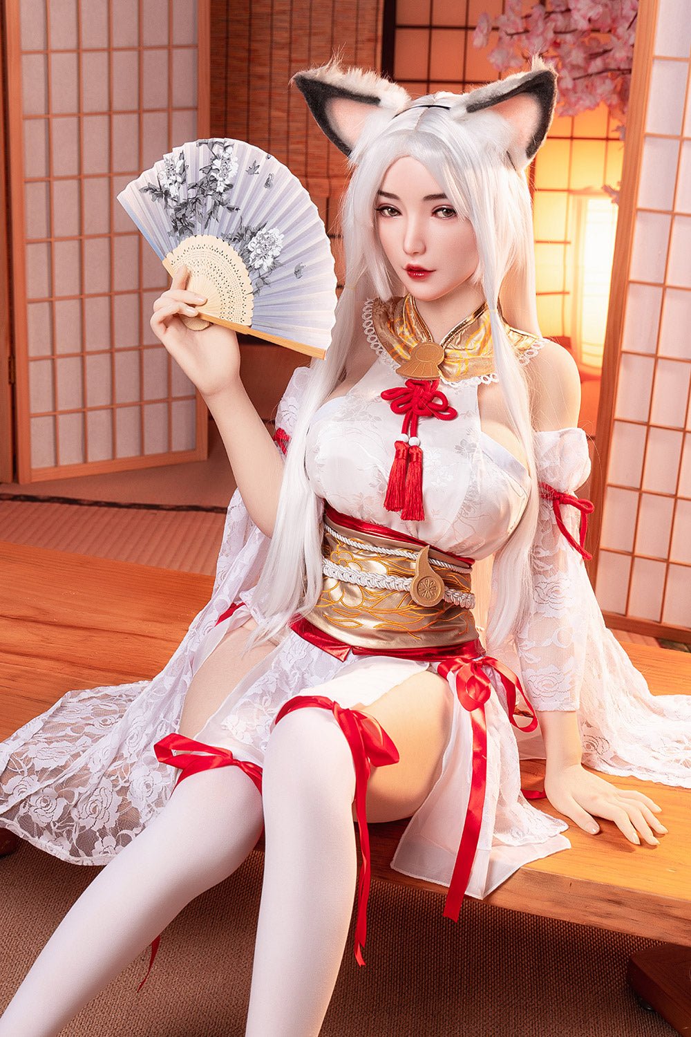Elegant anime-style cosplay doll dressed in traditional Japanese kimono with fox ears, holding a decorative fan, in a tatami room setting.