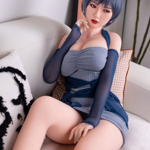 Realistic female love doll sitting on sofa, short blue hair, seductive pose, high-quality sex doll for adults, Seducedoll product image.