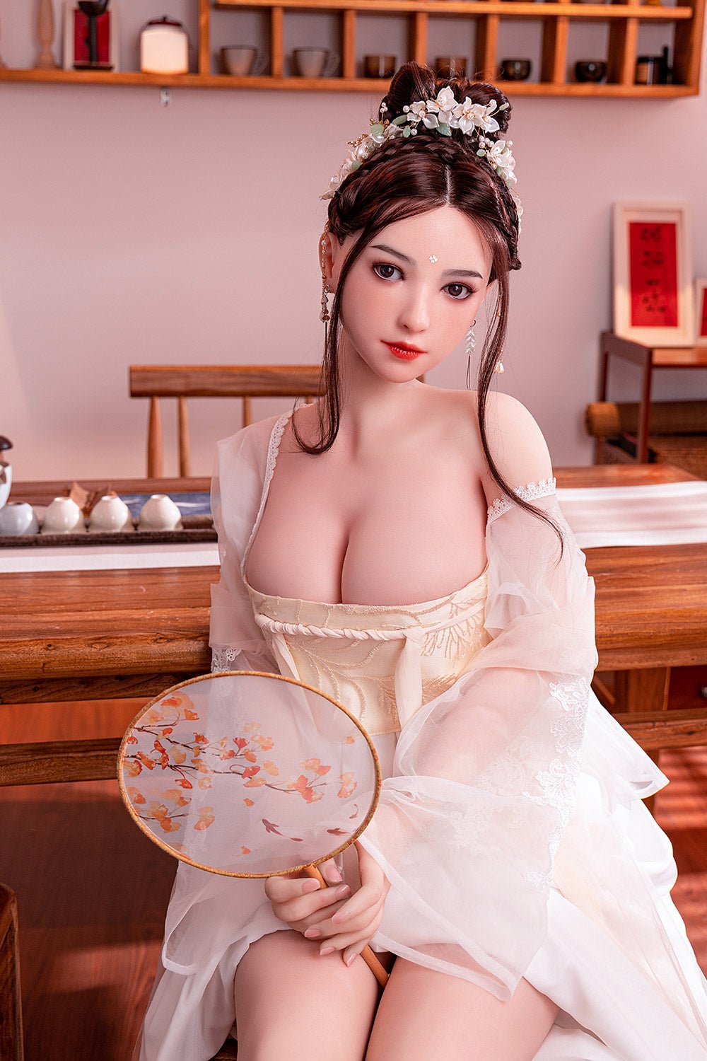 Delicate woman in traditional Chinese dress holding round fan, beautiful hair accessories, elegant oriental hairstyle, soft pink background, tea set in room.