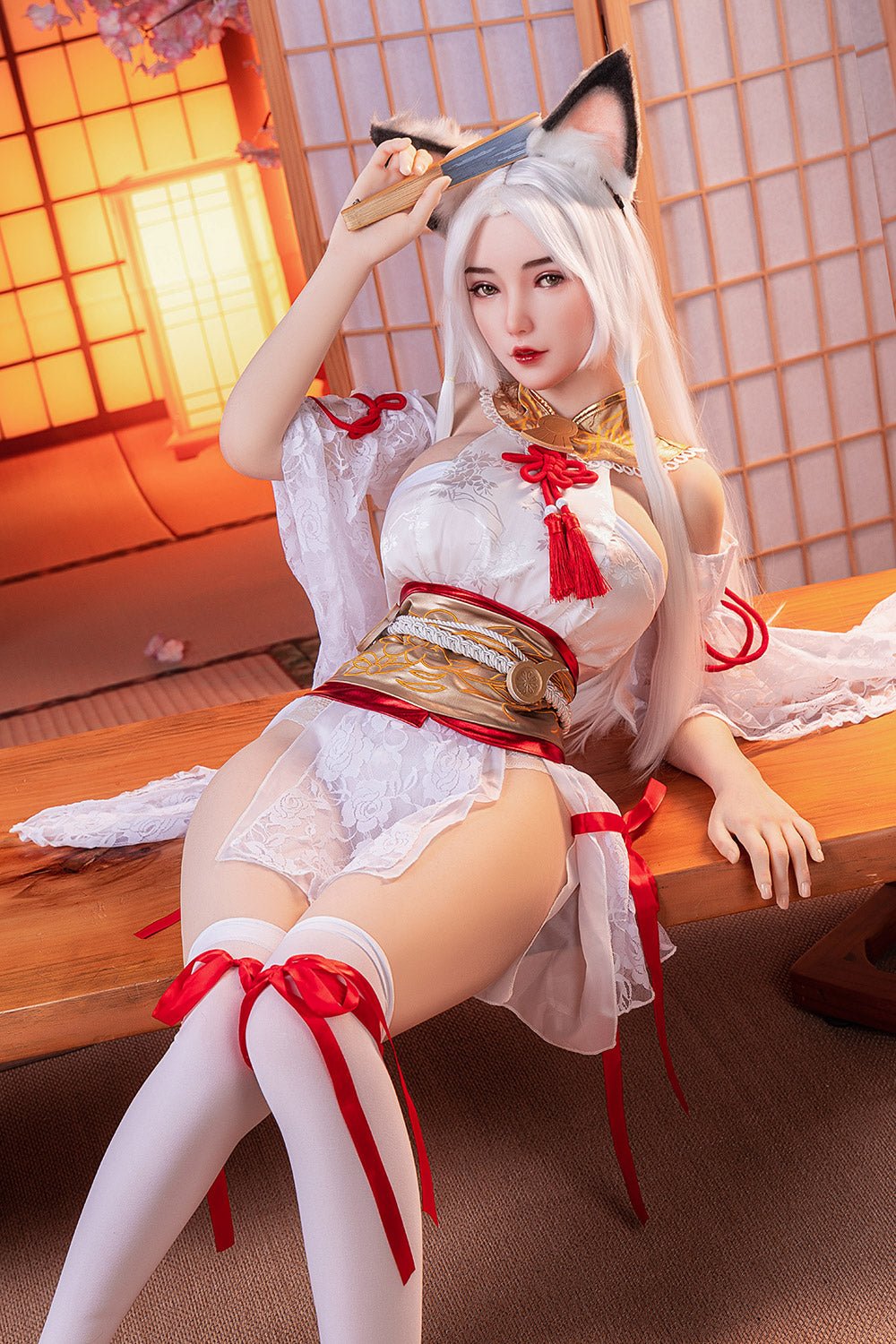 Silicone sex doll with anime-inspired fox girl costume, white lace, red ribbons, and long silver hair in a traditional Japanese room.