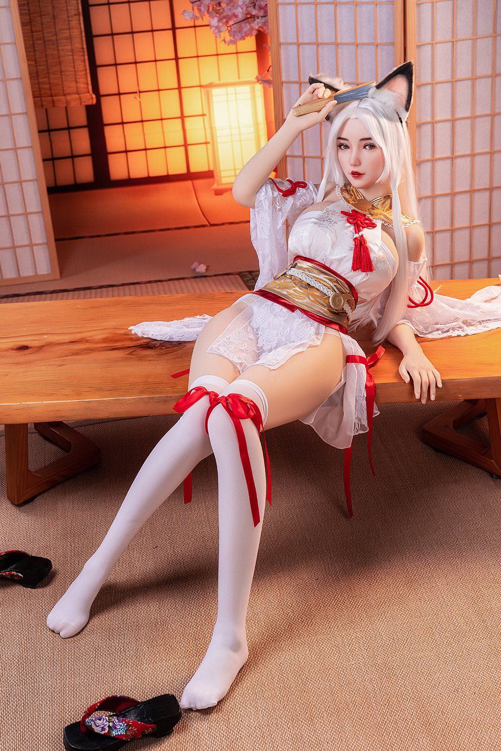 Silicone doll with fox ears in a Japanese-inspired room, dressed in a white and red cosplay outfit.