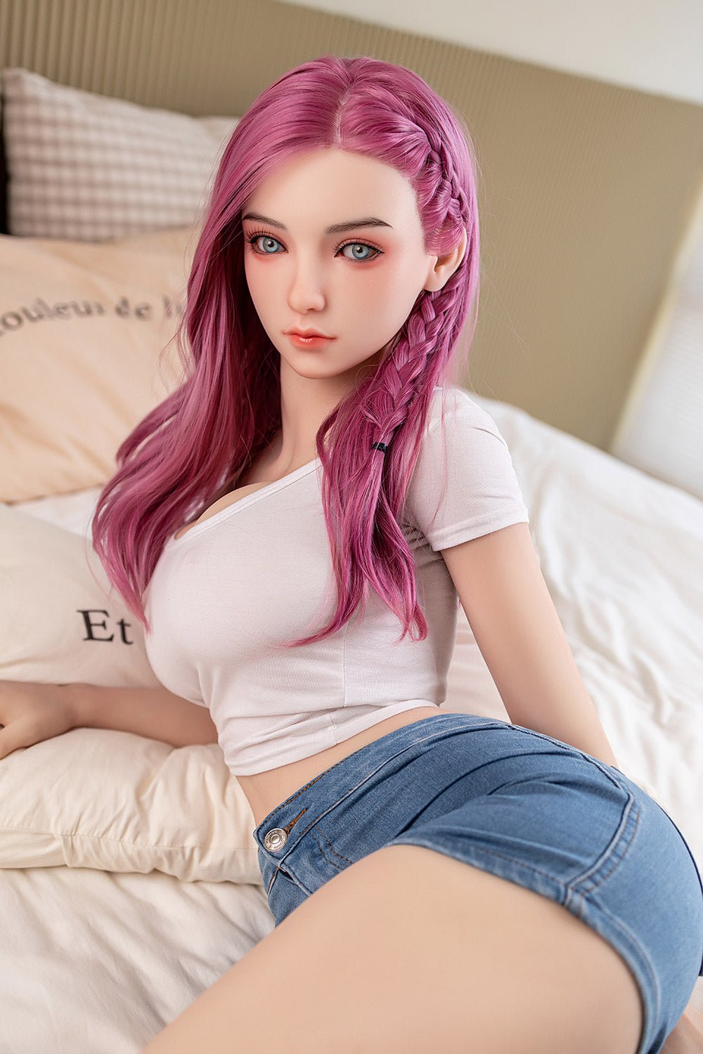 Realistic love doll with pink hair and blue eyes, lounging on a bed. Perfect for adult companionship and intimate experiences.