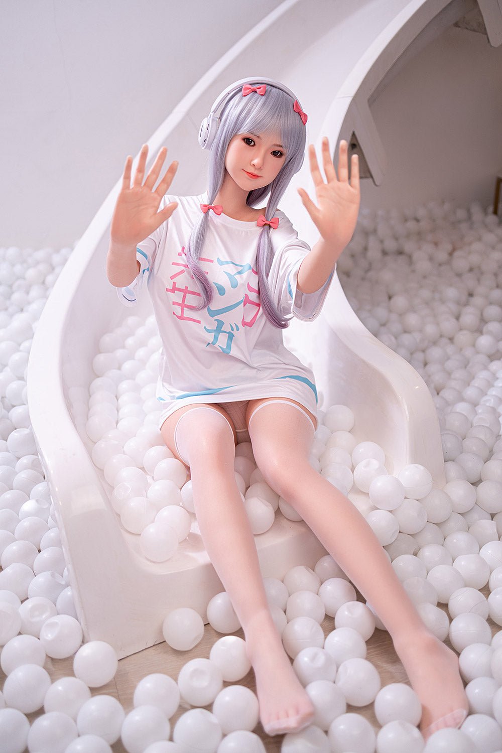 Cute doll with silver hair in a ball pit, wearing a pastel-themed outfit and headphones, creating a playful and adorable scene.