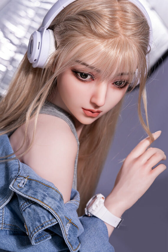 Realistic sex doll with blonde hair wearing headphones, posed for an attractive lifestyle shot.